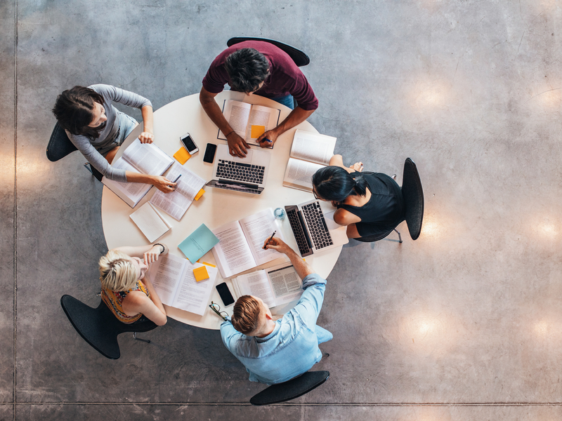 Plusieurs étudiants assis autour d'une table.