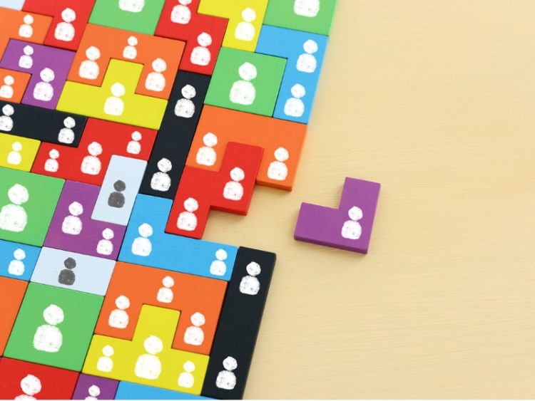 Image des blocs de puzzle de tangram avec des icônes de personnes au-dessus de la table en bois, des ressources humaines et du concept de gestion.