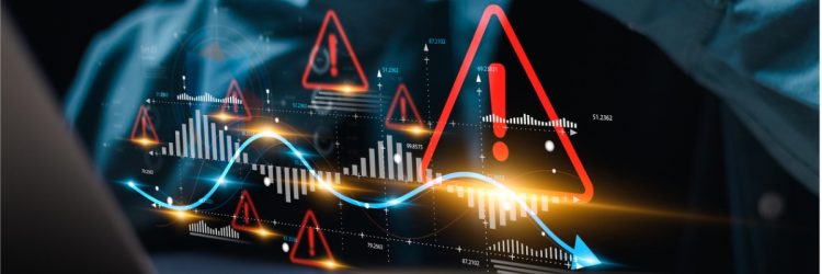 L’homme d’affaires utilise un ordinateur portable avec un graphique de croissance économique du monde virtuel avec un panneau d’avertissement rouge pour la prudence dans l’avertissement de la situation économique d’investissement, les risques.