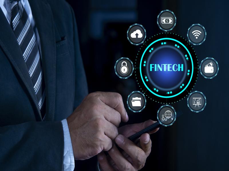 Un professionnel en complet utilise un téléphone mobile, entouré d’icônes liées à la fintech.